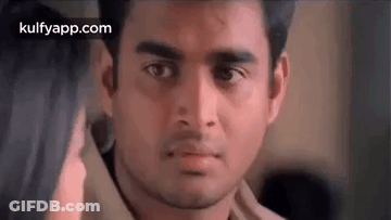 A Close Up Of A Man 'S Face With A Woman 'S Hand On His Shoulder . GIF