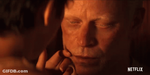 A Close Up Of A Man 'S Face With A Woman 'S Hand Touching It . GIF