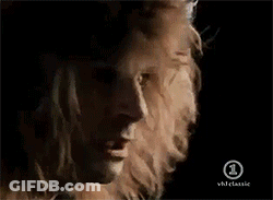 A Close Up Of A Man 'S Face With A Woman 'S Head In The Background GIF