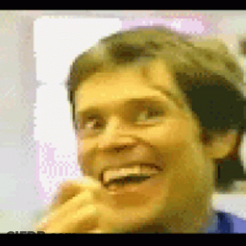 A Close Up Of A Man 'S Face With A Yellow Background GIF