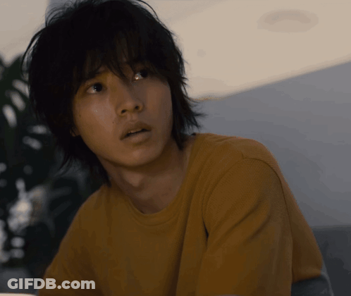 A Close Up Of A Man 'S Face With A Yellow Shirt GIF