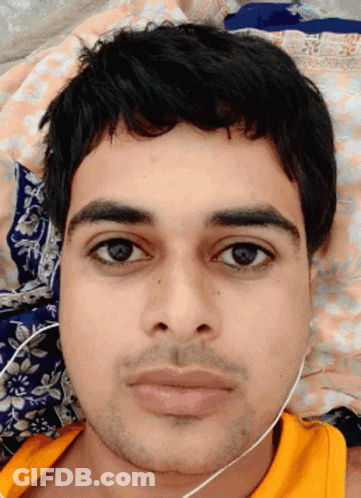 A Close Up Of A Man 'S Face With A Yellow Shirt GIF