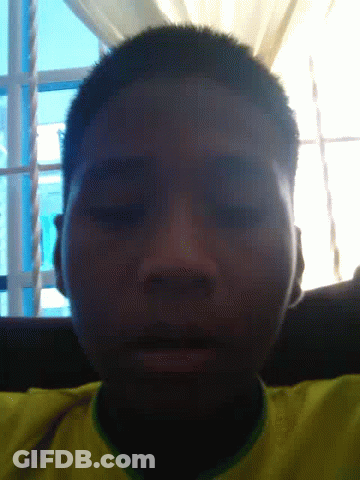 A Close Up Of A Man 'S Face With A Yellow Shirt GIF