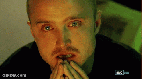 A Close Up Of A Man 'S Face With An Advertisement For A Tv Show Behind Him GIF