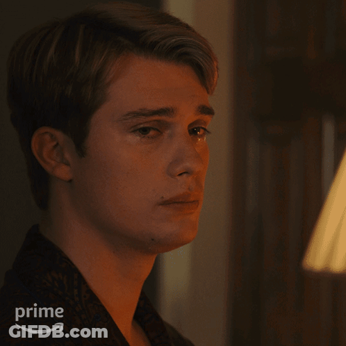 A Close Up Of A Man 'S Face With An Amazon Prime Logo In The Background GIF