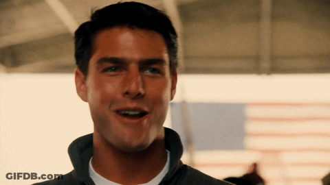 A Close Up Of A Man 'S Face With An American Flag Behind Him GIF