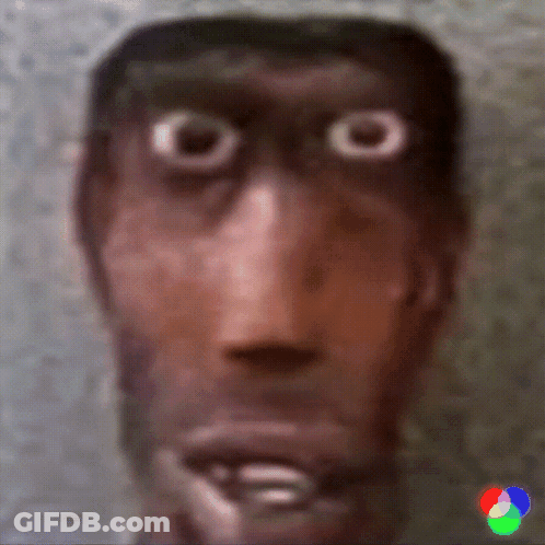 A Close Up Of A Man 'S Face With Big Eyes And A Blurred Background GIF