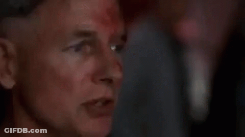 A Close Up Of A Man 'S Face With Blood On It And A Blurry Background . GIF