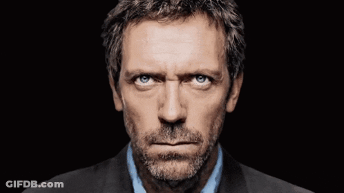 A Close Up Of A Man 'S Face With Blue Eyes GIF