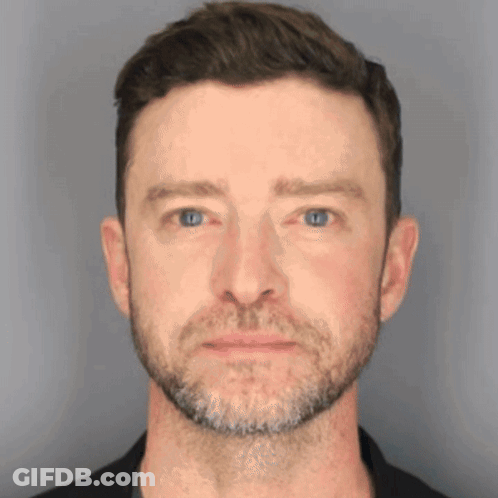 A Close Up Of A Man 'S Face With Blue Eyes And A Beard GIF