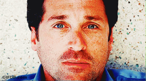 A Close Up Of A Man 'S Face With Blue Eyes And A Beard GIF