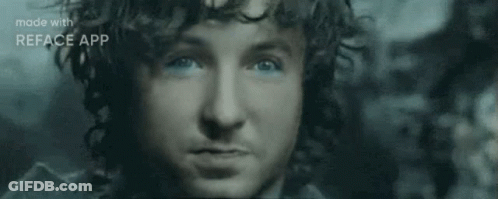 A Close Up Of A Man 'S Face With Blue Eyes And A Beard . GIF