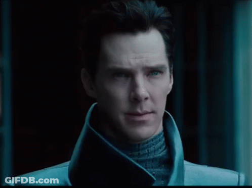 A Close Up Of A Man 'S Face With Blue Eyes And A Black Background GIF