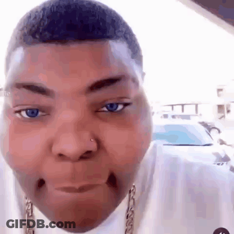 A Close Up Of A Man 'S Face With Blue Eyes And A Nose Ring . GIF