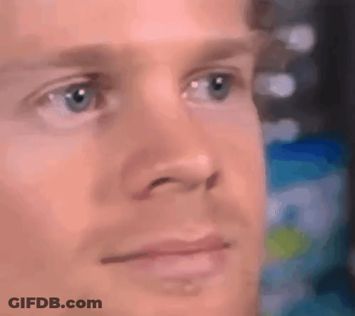 A Close Up Of A Man 'S Face With Blue Eyes And A Serious Look On His Face . GIF