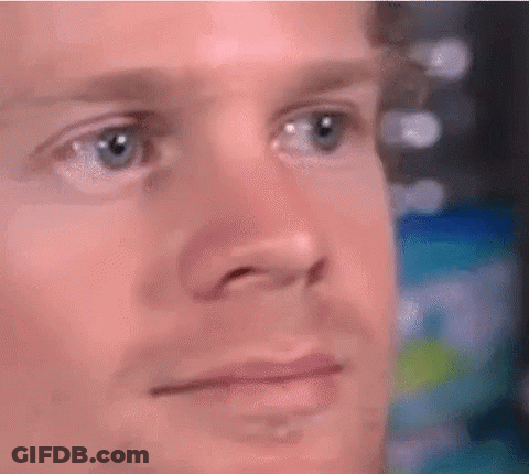 A Close Up Of A Man 'S Face With Blue Eyes And A Serious Look On His Face . GIF
