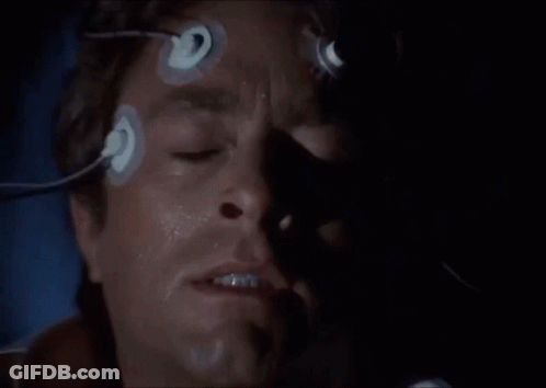 A Close Up Of A Man 'S Face With Blue Eyes And A Shadow On His Face . GIF