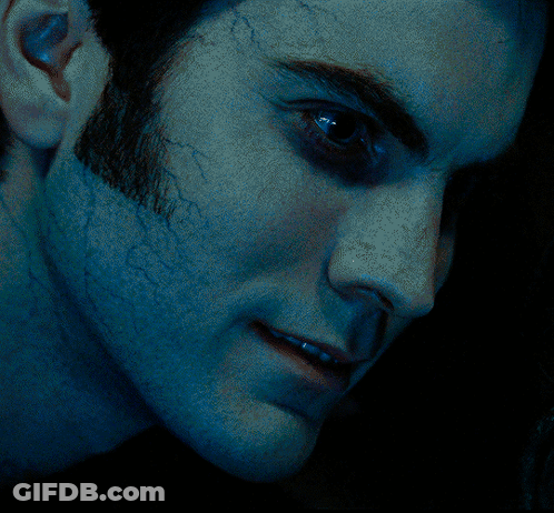 A Close Up Of A Man 'S Face With Blue Eyes GIF
