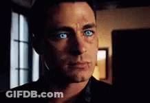A Close Up Of A Man 'S Face With Blue Eyes Looking At The Camera . GIF