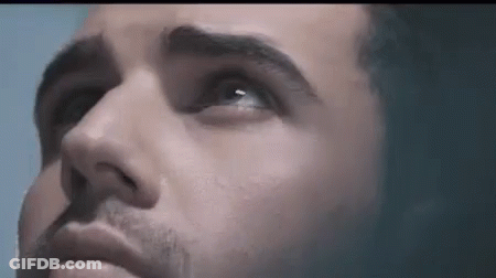 A Close Up Of A Man 'S Face With Blue Eyes Looking Up GIF
