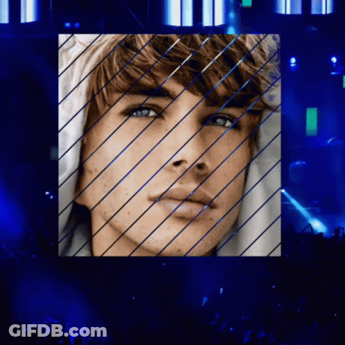 A Close Up Of A Man 'S Face With Blue Lines GIF