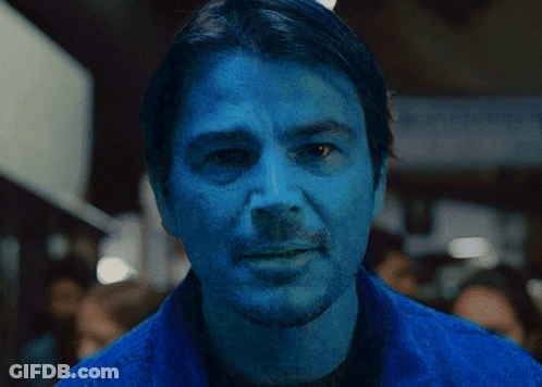 A Close Up Of A Man 'S Face With Blue Paint On It GIF