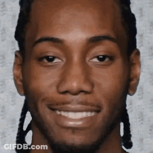 A Close Up Of A Man 'S Face With Braids And A Smile On His Face . GIF