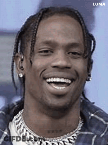 A Close Up Of A Man 'S Face With Braids And A Smile . GIF