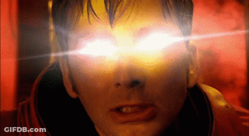 A Close Up Of A Man 'S Face With Bright Yellow Eyes GIF