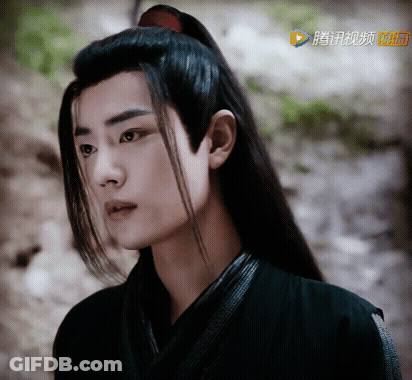 A Close Up Of A Man 'S Face With Chinese Characters On The Bottom GIF