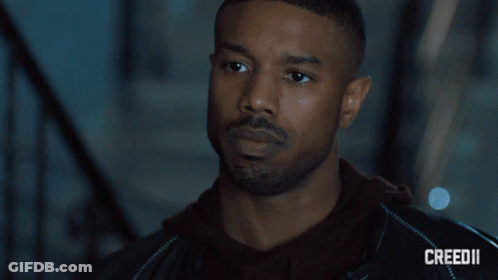 A Close Up Of A Man 'S Face With Creed Ii On The Bottom GIF