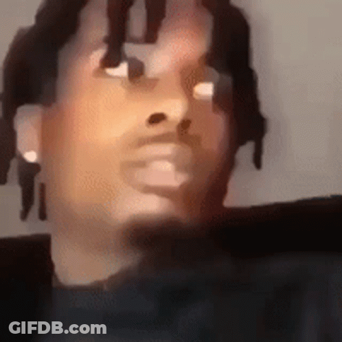 A Close Up Of A Man 'S Face With Dreadlocks And A Beard . GIF