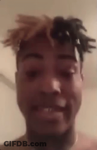 A Close Up Of A Man 'S Face With Dreadlocks On His Head . GIF