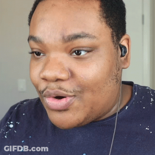 A Close Up Of A Man 'S Face With Ear Buds On GIF