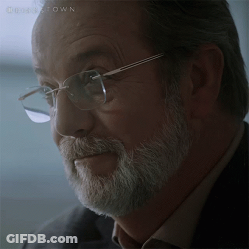 A Close Up Of A Man 'S Face With Glasses And A Beard With The Hashtag #Disestown On The Bottom GIF