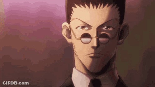A Close Up Of A Man 'S Face With Glasses And A Tie . GIF