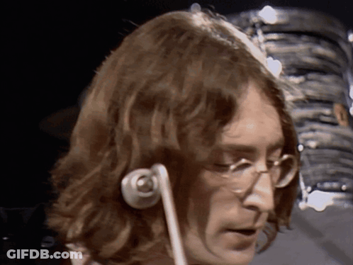 A Close Up Of A Man 'S Face With Glasses And Headphones GIF