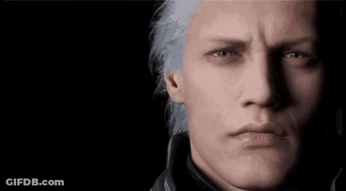 A Close Up Of A Man 'S Face With Gray Hair And Blue Eyes . GIF