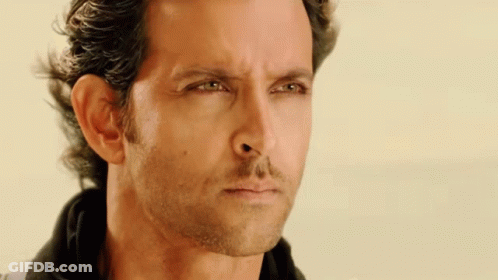 A Close Up Of A Man 'S Face With Green Eyes GIF