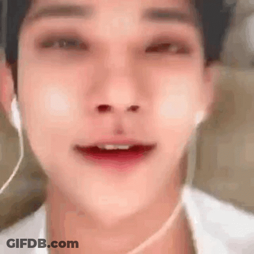 A Close Up Of A Man 'S Face With Headphones On . GIF