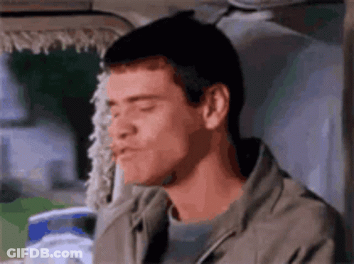 A Close Up Of A Man 'S Face With His Eyes Closed . GIF