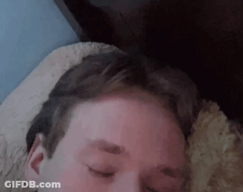 A Close Up Of A Man 'S Face With His Eyes Closed GIF