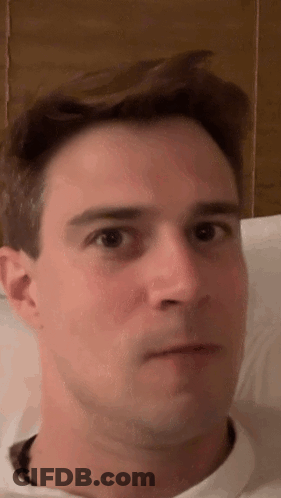 A Close Up Of A Man 'S Face With His Eyes Closed . GIF