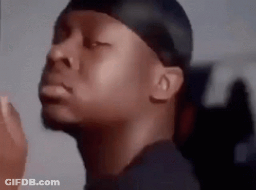 A Close Up Of A Man 'S Face With His Eyes Closed And A Bandana On His Head . GIF