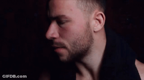 A Close Up Of A Man 'S Face With His Eyes Closed And A Beard GIF