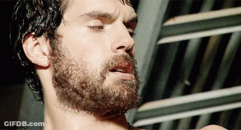A Close Up Of A Man 'S Face With His Eyes Closed And A Beard With The Word Simply On The Bottom GIF