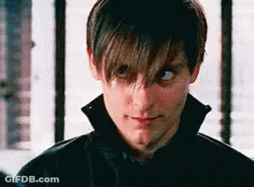 A Close Up Of A Man 'S Face With His Eyes Closed And A Black Jacket On . GIF