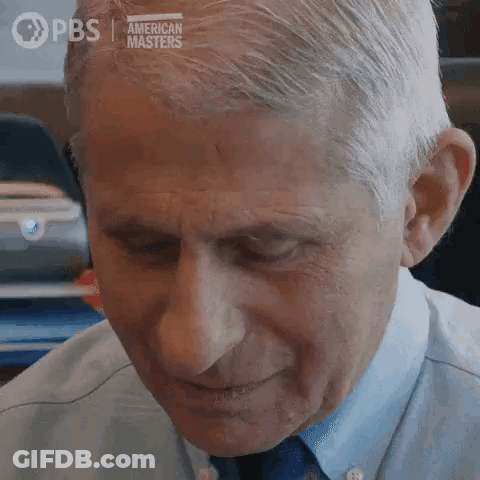 A Close Up Of A Man 'S Face With His Eyes Closed And A Blue Shirt And Tie . GIF