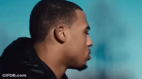 A Close Up Of A Man 'S Face With His Eyes Closed And A Blue Sky In The Background . GIF