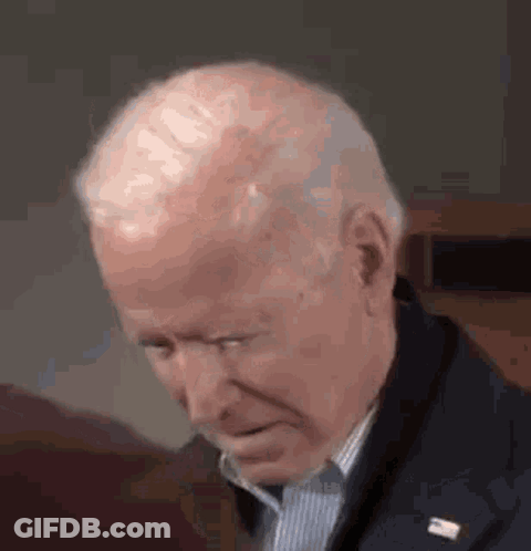 A Close Up Of A Man 'S Face With His Eyes Closed And A Lapel Pin . GIF
